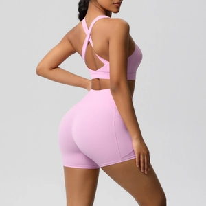 Close-up of pink sports set featuring high-waisted shorts and X-back strap detail