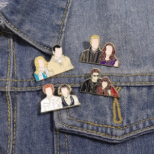 Detail of artistic alloy enamel pins featuring film characters on blue denim jacket