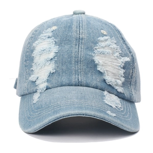 Close-up of light blue washed denim baseball cap with vintage distressed ripped details
