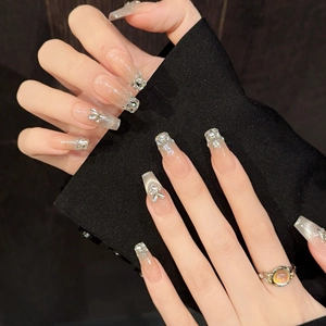 Long coffin handmade press-on nails with nude pink gradient and silver diamond butterfly