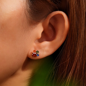 Close-up of S925 sterling silver studs with colorful square-cut gemstones on ear