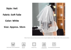 Detail of short white bridal veil with soft tulle layers and ribbon bow decor