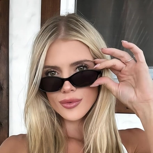 Retro small oval frame sunglasses with black lenses for a minimalist vintage fashion look