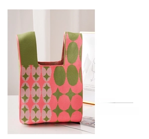 Close-up of knit tote bag with green and pink geometric patterns and thick texture