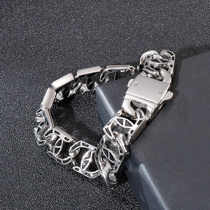 Detail of silver stainless steel chain bracelet on textured geometric background
