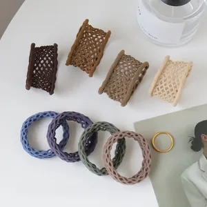 Detailed view of elastic mesh scrunchies in eight colors with minimalist lifestyle decor