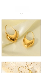 Macro shot of V-shaped 18K gold-plated earrings with polished thick curved texture
