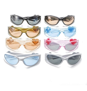 Flat lay display of Y2K heart sunglasses in eight different jelly colors with cat eye frames