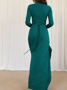 Detailed back view of dark green slim fit maxi dress featuring crisscross tie-up design
