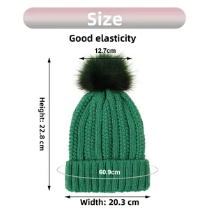 Size chart for dark green knit beanie with pom-pom showing height 22.8cm and width 20.3cm