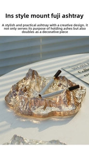 Detailed close-up of amber glass ashtray with iceberg design and cigarette holder