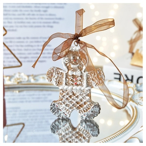 Detailed view of gingerbread man ornament with lace texture and brown ribbon on mirror