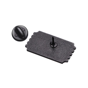 Macro shot of matte black enamel pin backing with metal pin needle and rubber clutch