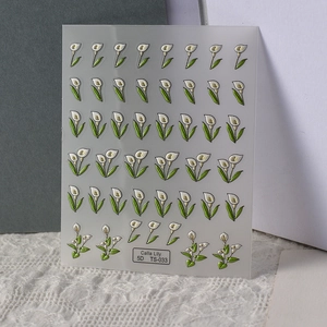 Macro detail of 5D embossed white calla lily nail stickers with textured 3D floral pattern