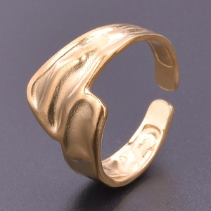 Close-up of golden adjustable ring featuring a unique irregular wavy texture finish