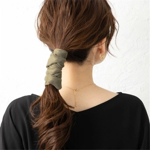 Olive green fabric wire hair tie for low ponytail decoration on brunette wavy hair