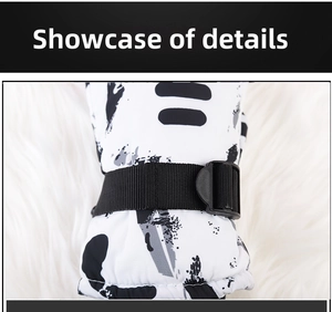 Detail view of winter ski gloves showing waterproof floral fabric and nylon buckle strap