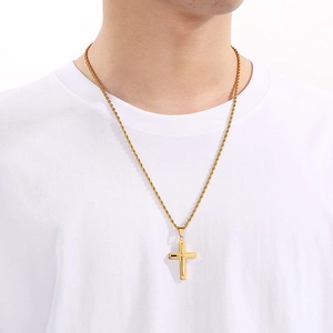Gold stainless steel cross pendant necklace with twist rope chain worn on model
