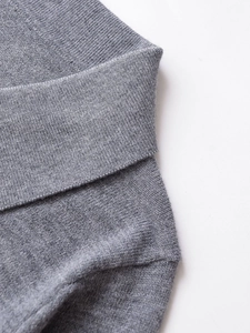 Close-up of the grey ribbed knit cuffs and fine texture on a long sleeve polo sweater