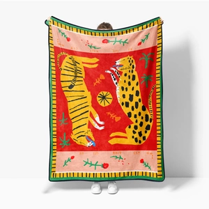 Detail of flannel blanket featuring red tiger leopard print and Big Cats Don't Cry text