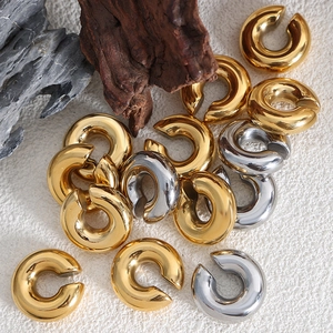 Polished C-shape thick hoop earrings in gold and silver finish on artistic stones