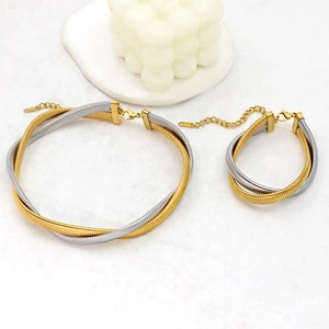 Detail view of two-tone braided stainless steel necklace and bracelet jewelry set