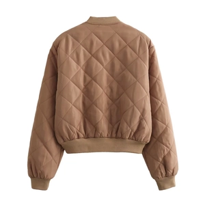 Detail view of the brown quilted bomber jacket featuring diamond stitching and ribbed cuffs