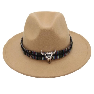 Close-up of ethnic woven band and silver bull head metal ornament on camel wool felt hat