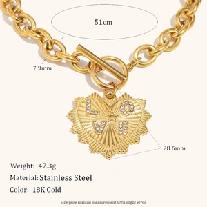 Macro view of gold stainless steel toggle necklace with engraved LOVE heart pendant details