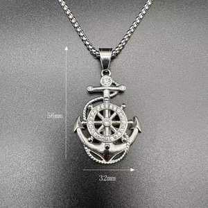 Detailed view of silver anchor pendant with rhinestones measuring 56mm by 32mm