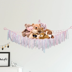 Pink hand-woven plush toy storage hammock with tassels and plush dolls in Nordic style