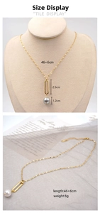Detail of gold chain necklace with hollow oval pendant and 12mm grey pearl accessory