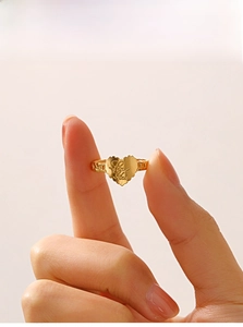 Close-up of 18K gold-plated heart ring with Love You engraving and hollow band