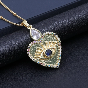 Macro shot of heart-shaped evil eye pendant with colorful gems on black leather