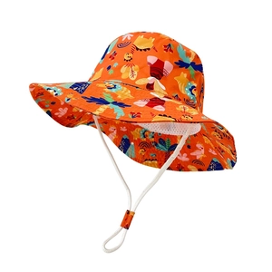 Detail of orange kids sun hat with dinosaur prints and adjustable windproof strap