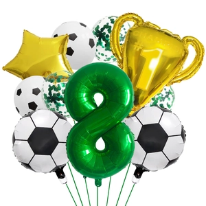 Detail of football party kit with green number 8, golden trophy and soccer balloons