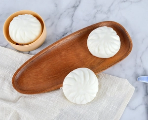 Three squishy PU slow rebound buns with realistic texture on a wooden tray