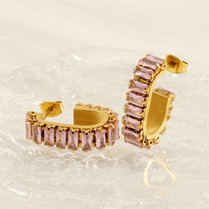 Detailed view of gold C-shaped earrings set with elegant pink rectangular zircons
