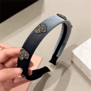 Detail of gradient blue velvet headband with sparkling heart rhinestones and non-slip lining