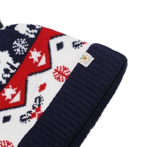 Close-up of knit winter hat featuring reindeer snowflake jacquard and ribbed cuff