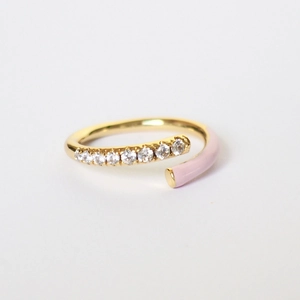 Detail of gold open ring featuring micro-paved zircons and pink enamel finish
