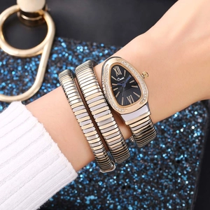 Detail of snake-shaped wrap watch with crystal-encrusted teardrop dial on a model wrist
