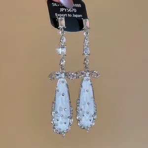 Elegant 1000 silver drop earrings with zircon bow and white teardrop stone pendants