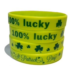 Set of four neon yellow silicone St. Patrick's Day wristbands with lucky clover patterns