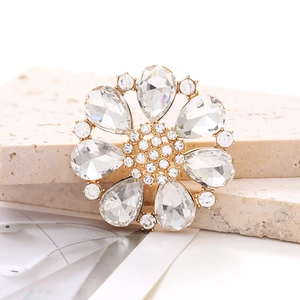 Detailed close-up of a golden alloy flower shoe charm with crystal rhinestones