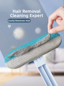 Close-up of a blue manual pet hair remover lifting lint from gray textile surfaces