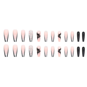 Long ballerina press-on nails with black V-French tips, silver snake motifs, and glitters