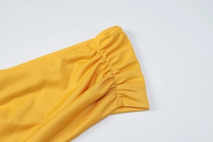 Detailed macro view of yellow ribbed elastic cuff on a stylish sleeveless dress