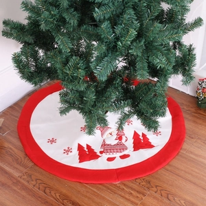 Detail view of premium embroidered Christmas tree skirt with Santa and cedar patterns