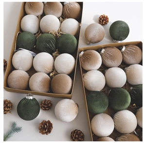 Close-up of 8cm velvet Christmas balls with flocked texture and decorative pine cones